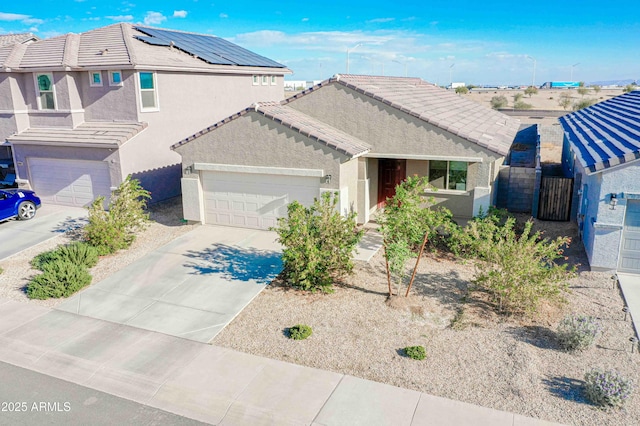 view of front of house with a garage and solar panels