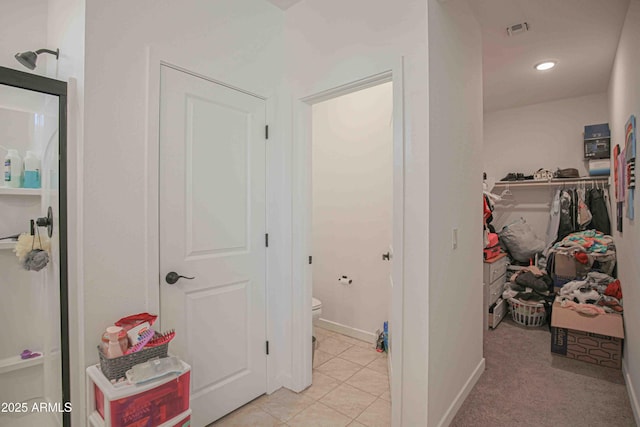 hall featuring light tile patterned floors