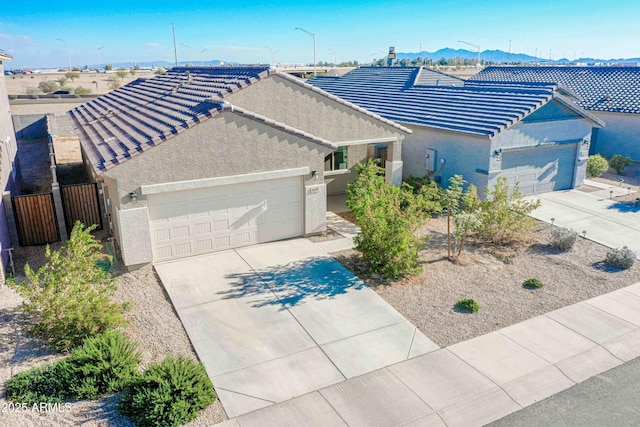 single story home featuring a mountain view and a garage