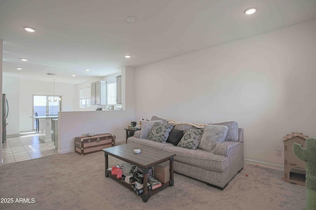 living room with a chandelier and light tile patterned floors