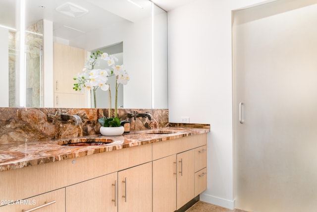 7117 E Rancho Vista Dr Unit 1012, Scottsdale, AZ 85251 - bathroom featuring double vanity, a stall shower, and tasteful backsplash