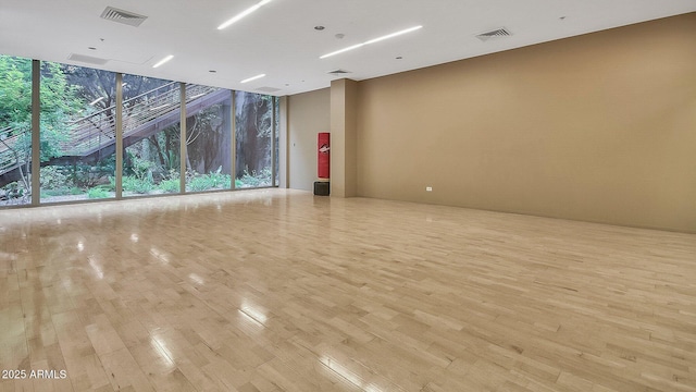 7117 E Rancho Vista Dr Unit 1012, Scottsdale, AZ 85251 - empty room featuring floor to ceiling windows and light wood-type flooring
