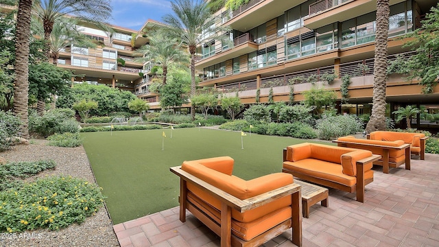 7117 E Rancho Vista Dr Unit 1012, Scottsdale, AZ 85251 - view of home's community with a putting green, an outdoor hangout area, and a patio area