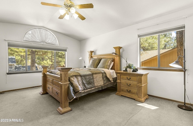 bedroom with vaulted ceiling, multiple windows, and light colored carpet