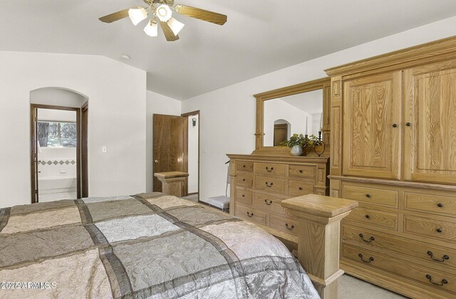 bedroom featuring connected bathroom, vaulted ceiling, and ceiling fan