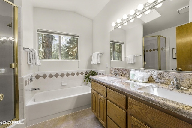 bathroom with a bath, double vanity, a sink, and a stall shower