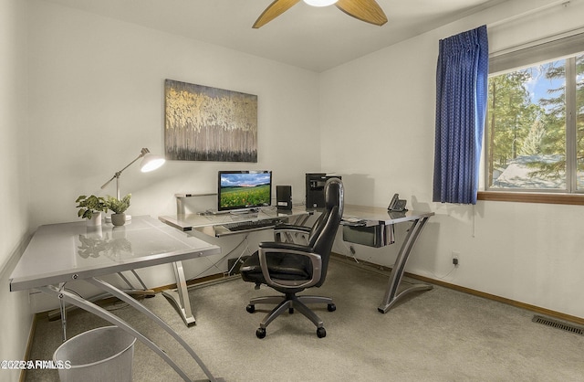 carpeted office space with a ceiling fan, baseboards, and visible vents
