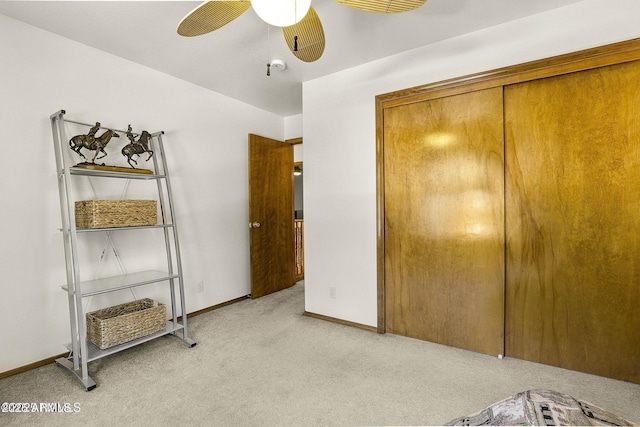 bedroom with baseboards, a ceiling fan, and light colored carpet