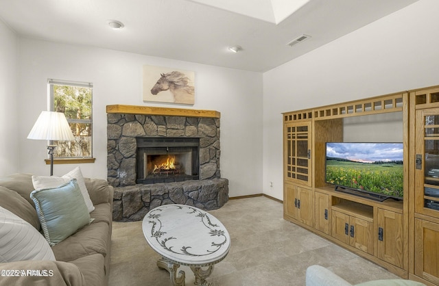 living room featuring baseboards, a fireplace, and visible vents