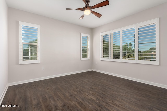 unfurnished room featuring dark wood-type flooring and ceiling fan