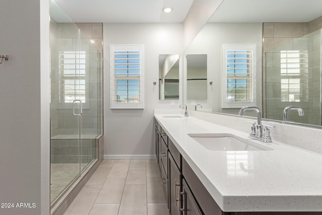 bathroom with walk in shower, tile patterned floors, vanity, and a wealth of natural light