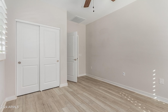 unfurnished bedroom featuring a closet, ceiling fan, and light hardwood / wood-style flooring