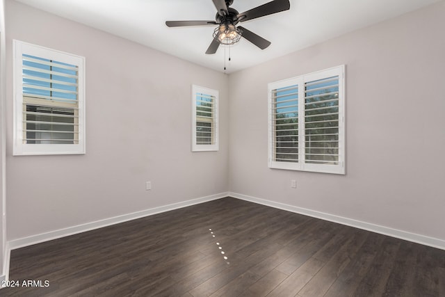 unfurnished room featuring dark hardwood / wood-style floors and ceiling fan