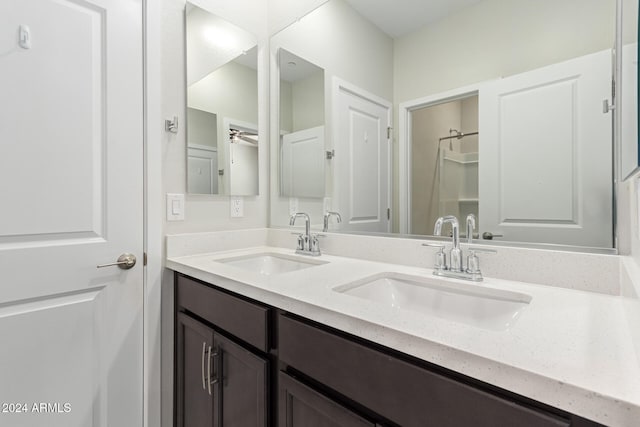 bathroom with ceiling fan and vanity