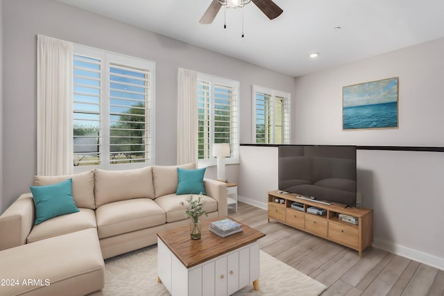 living room with ceiling fan and light wood-type flooring