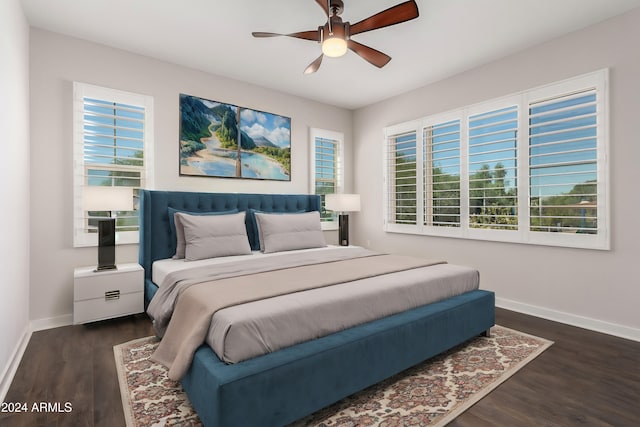 bedroom with multiple windows, dark wood-type flooring, and ceiling fan