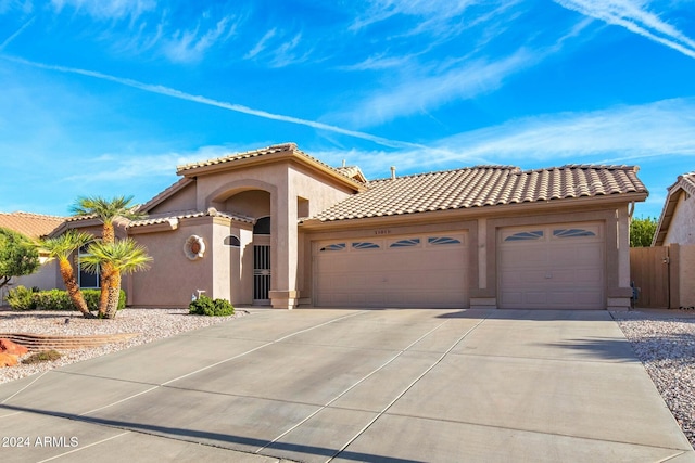 mediterranean / spanish house with a garage