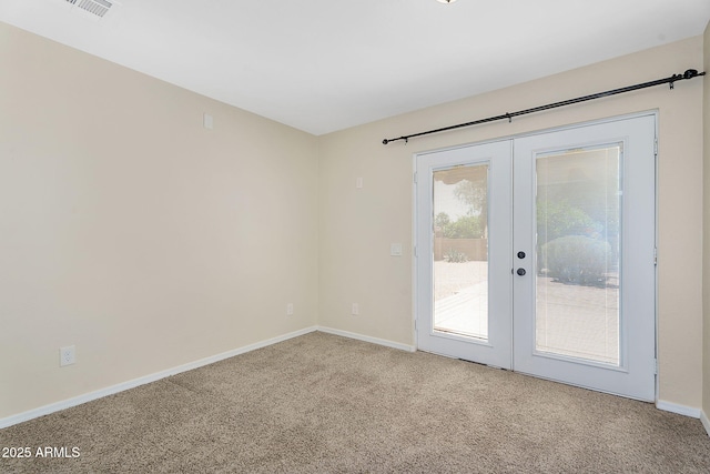 empty room with french doors, carpet flooring, and baseboards