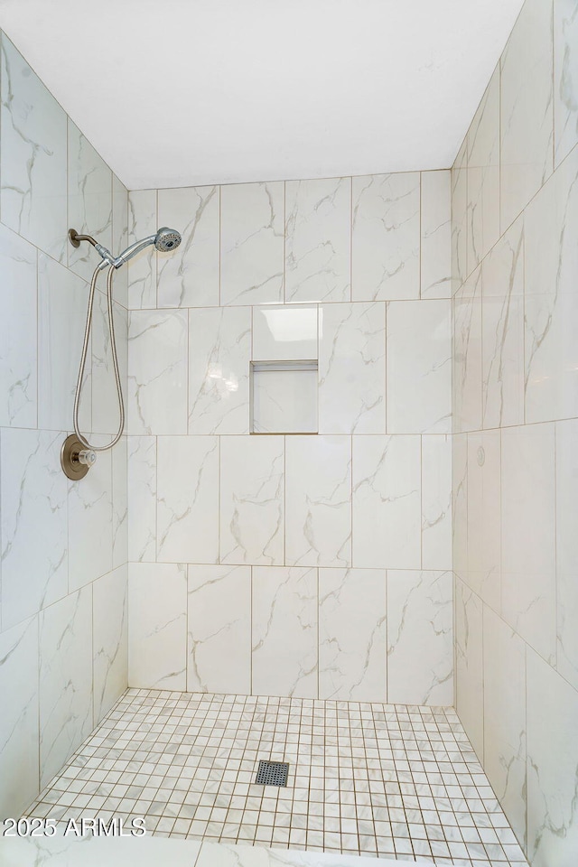 bathroom with tiled shower