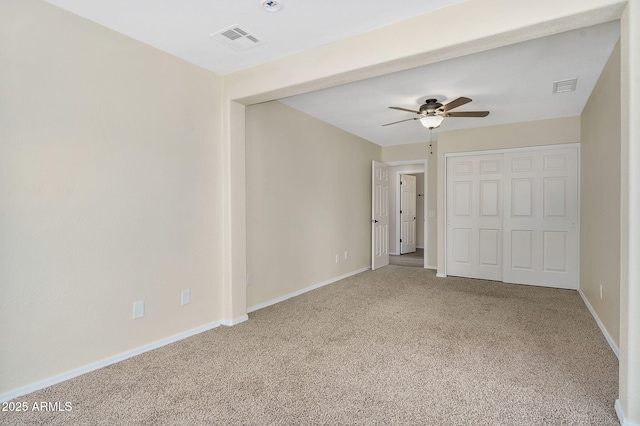 unfurnished bedroom with carpet floors, baseboards, a closet, and ceiling fan