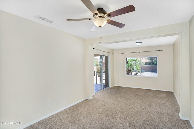 empty room featuring carpet floors, a ceiling fan, and baseboards