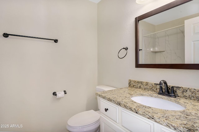 full bath featuring toilet, vanity, and a shower
