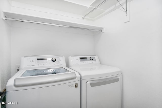 washroom with washer and dryer