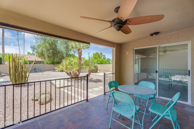 view of patio featuring ceiling fan, a fenced backyard, and outdoor dining area