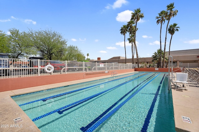 view of pool featuring fence