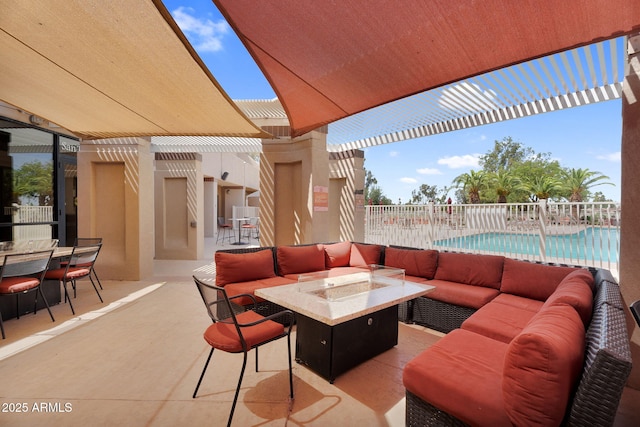view of patio / terrace with an outdoor living space with a fire pit, a pergola, a community pool, and outdoor dining area