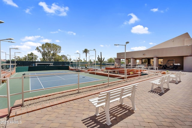 view of tennis court with fence