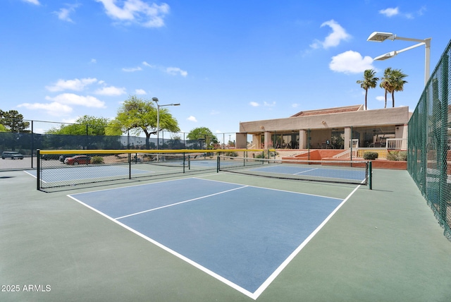 view of tennis court featuring fence