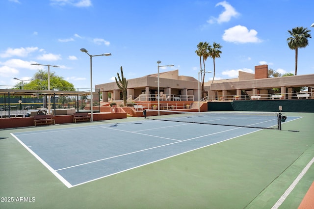 view of tennis court featuring fence