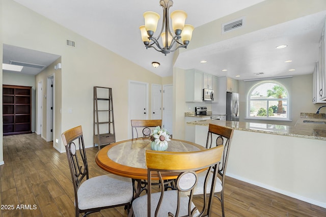 dining space with dark wood finished floors, baseboards, a chandelier, lofted ceiling, and recessed lighting