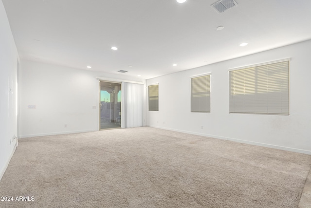 empty room featuring light colored carpet