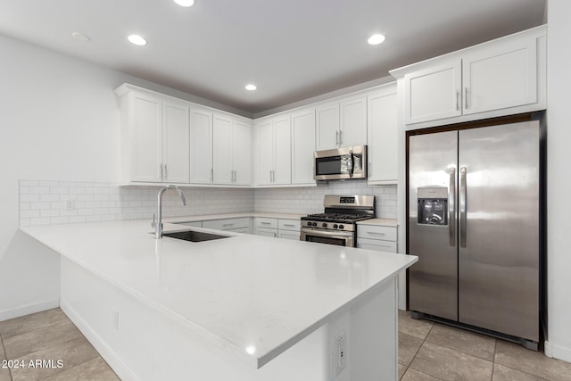 kitchen with appliances with stainless steel finishes, white cabinets, and sink