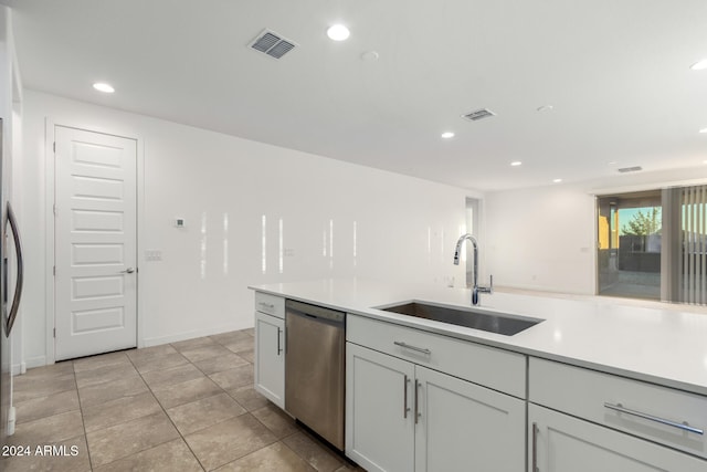 kitchen with light tile patterned floors, sink, and dishwasher