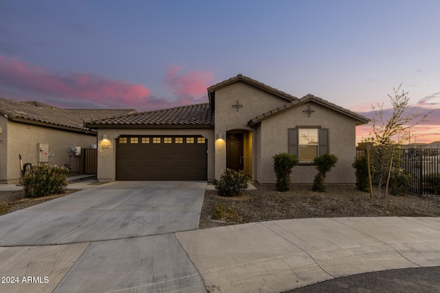 mediterranean / spanish home with a garage