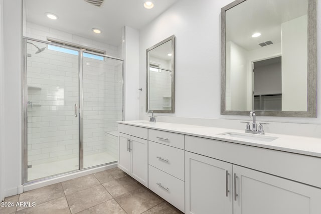 bathroom featuring vanity, an enclosed shower, and tile patterned floors