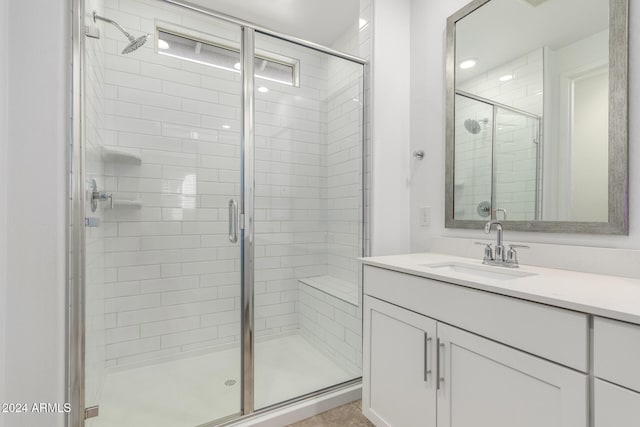 bathroom featuring vanity and an enclosed shower