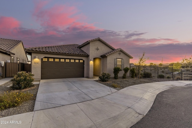 mediterranean / spanish-style house featuring a garage