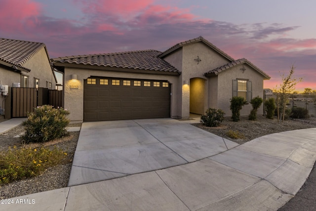 mediterranean / spanish house featuring a garage