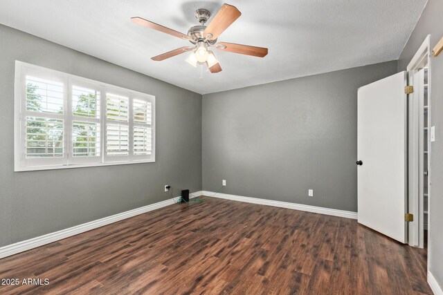 2161 E Harmony Cir, Mesa, AZ 85204 - spare room with dark wood-style floors and ceiling fan