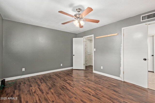 2161 E Harmony Cir, Mesa, AZ 85204 - unfurnished bedroom with wood finished floors and a ceiling fan