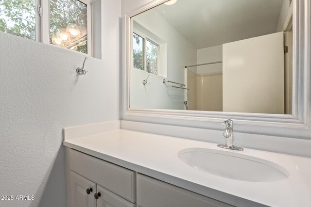 2161 E Harmony Cir, Mesa, AZ 85204 - full bathroom featuring vanity and a textured wall