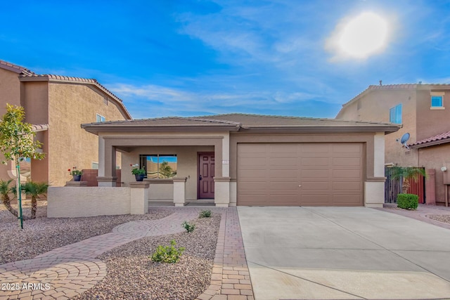 view of front facade with an attached garage, driveway, fence, and stucco siding