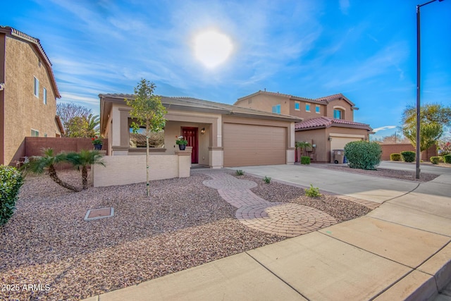 mediterranean / spanish home featuring a garage, concrete driveway, fence, and stucco siding