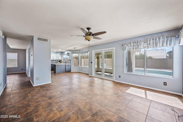 1638 N Avoca, Mesa, AZ 85207 - unfurnished living room with a ceiling fan, plenty of natural light, and baseboards