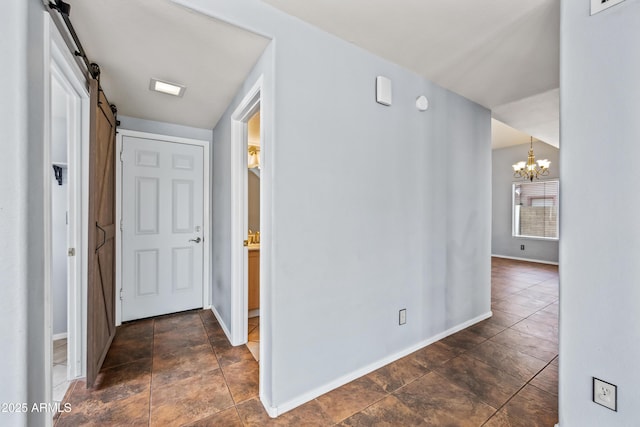 1638 N Avoca, Mesa, AZ 85207 - hallway with a chandelier, baseboards, and a barn door