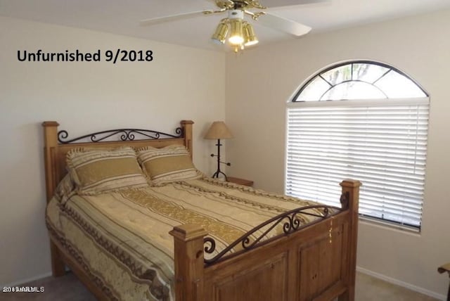 bedroom featuring baseboards, carpet floors, and a ceiling fan